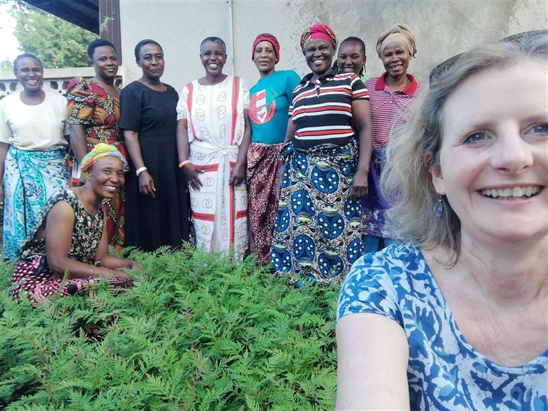 Woman taking a selfiw with a group of women behind her