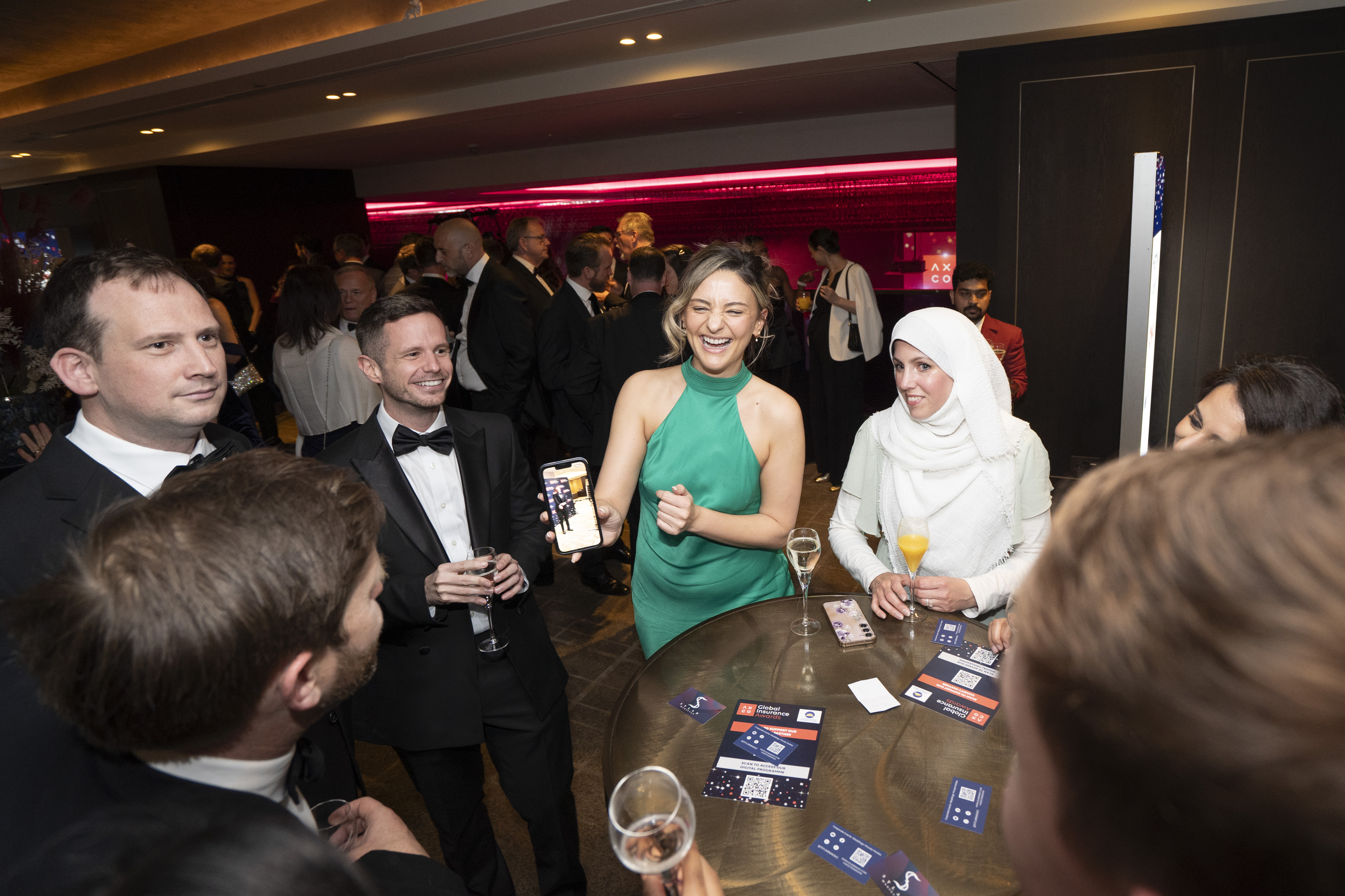 People stood around a table talking