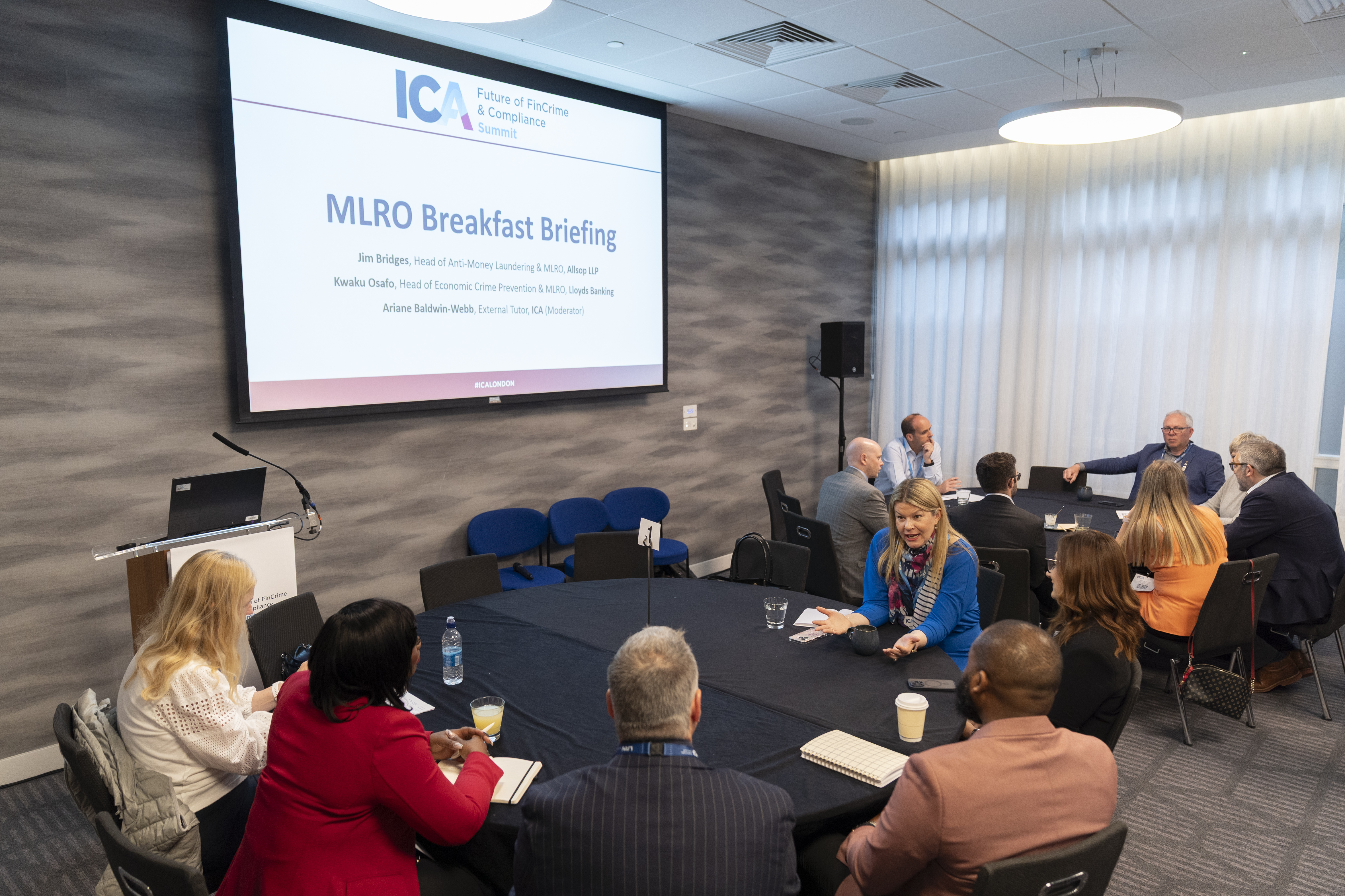 People sat around tables in discussion