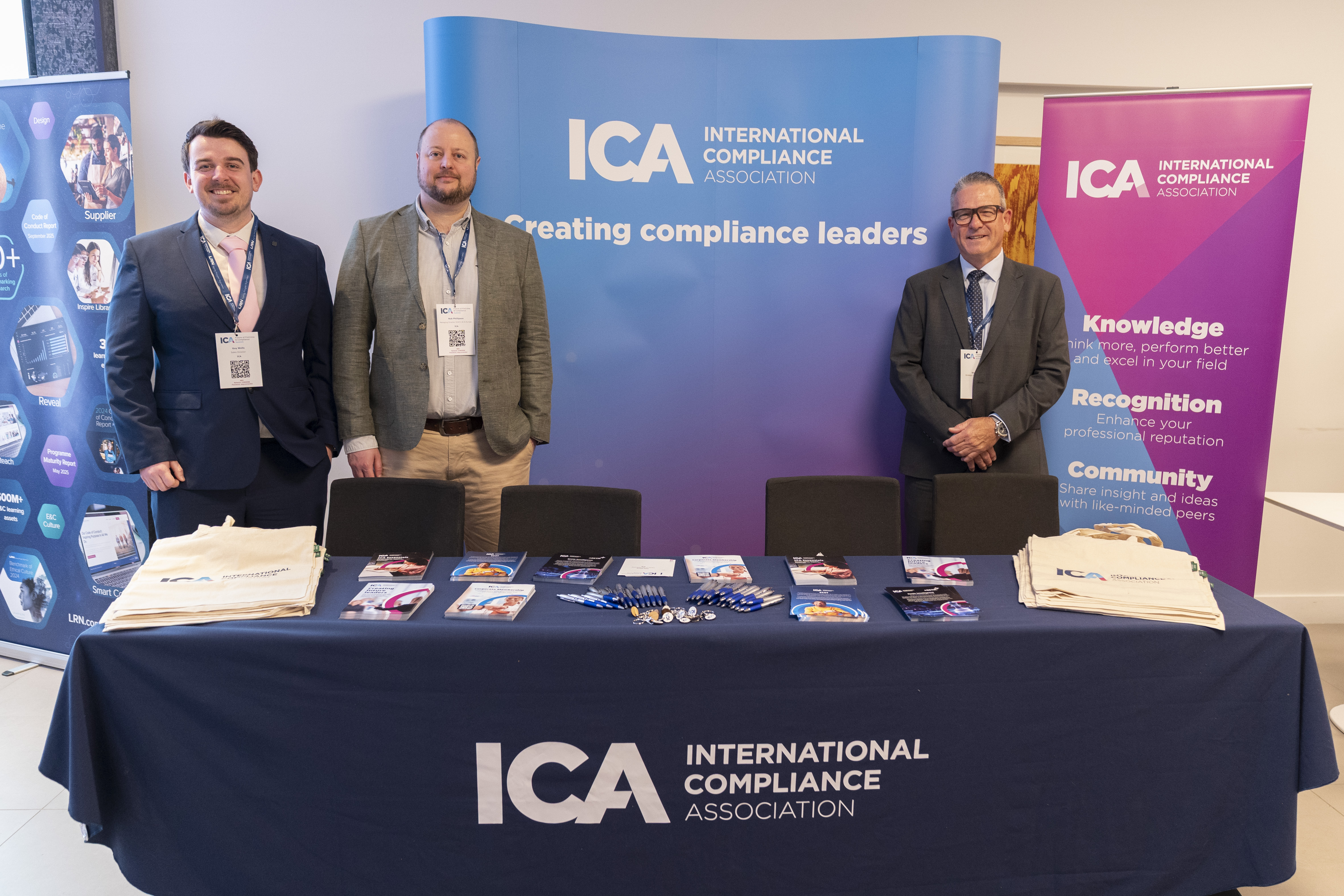 Three men stood behind an exhibition table