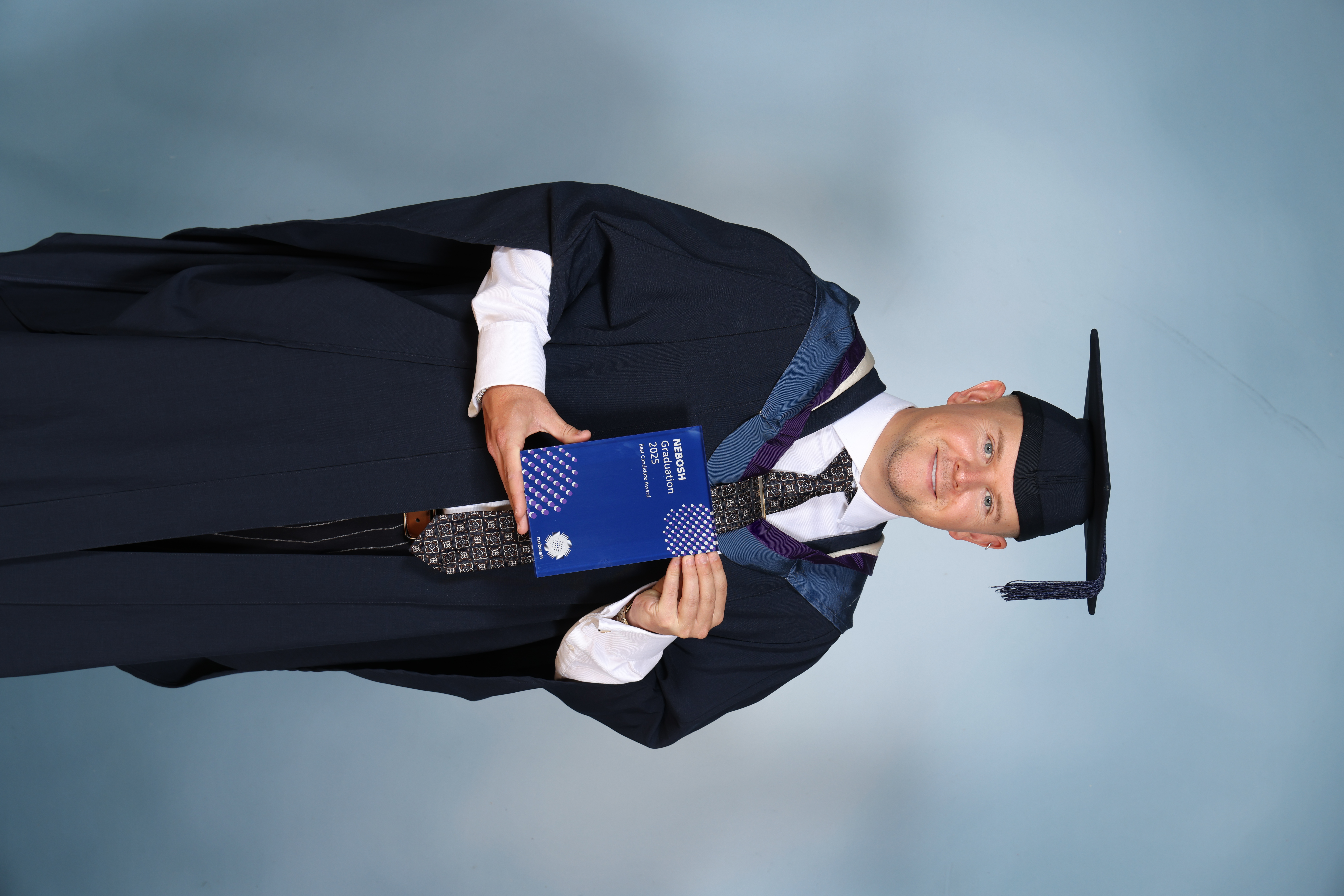 Man in a graduation cap and gown