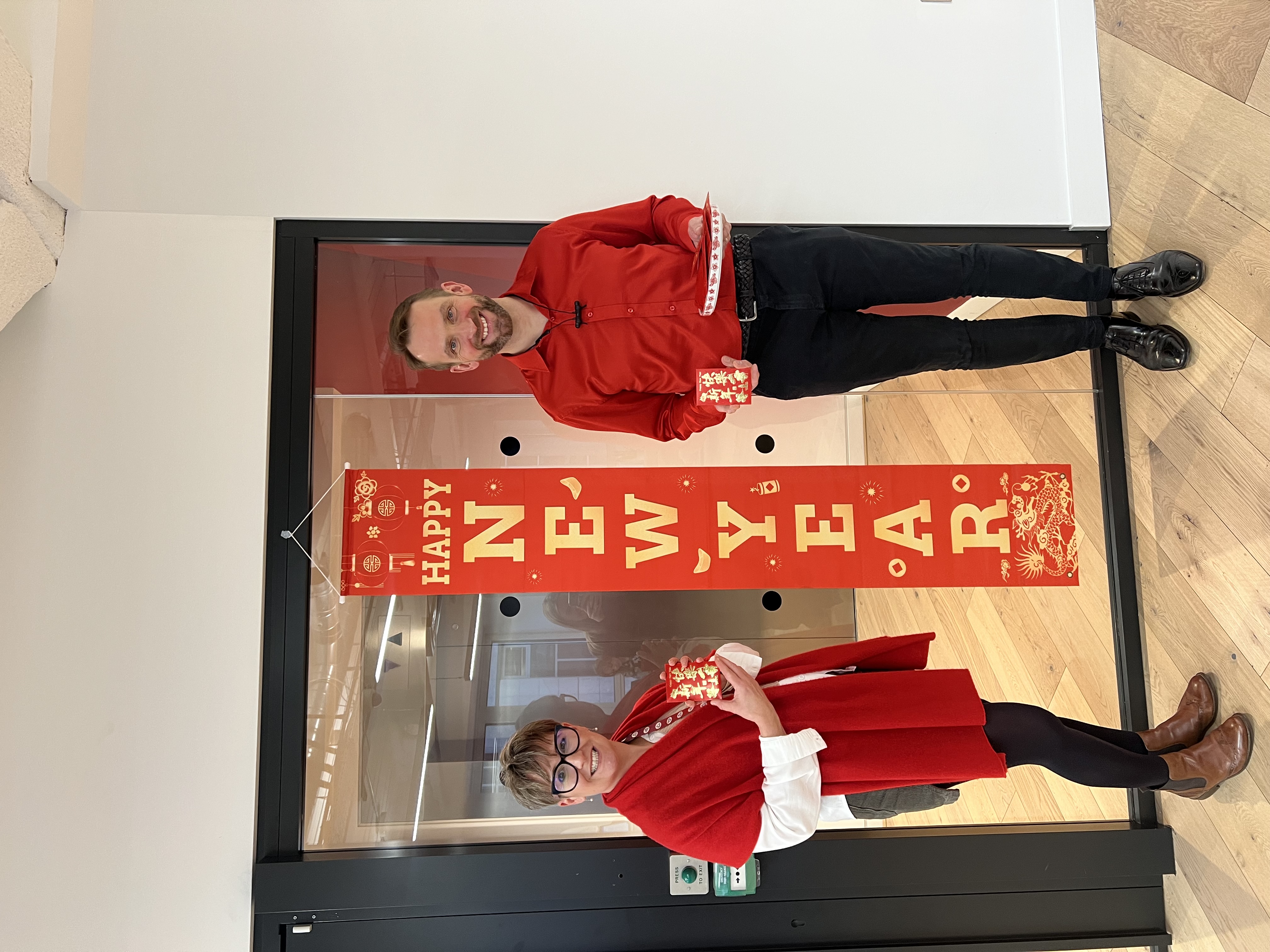 Man and woman standing by a banner